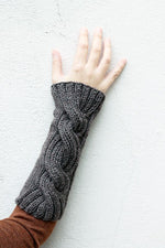 Cable wrist warmers in brown yarn