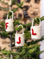 Crochet treat bags hanging on a Christmas tree
