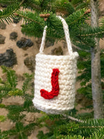 crochet bag on christmas tree with a crochet letter