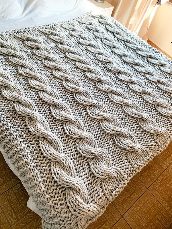 chunky knit blanket on a large bed