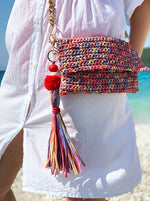 crochet summer bag made from raffia with a long tassel charm