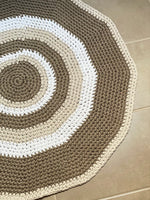 crochet circle rug on a bathroom tiled floor