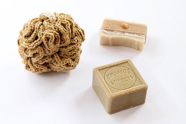 crochet shower puff next to two bars of soap
