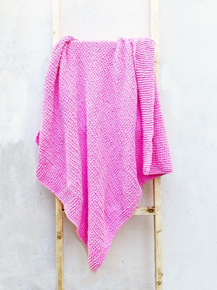 Large baby blanket knit with pink yarn