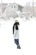 woman wearing a black knitted scarf in the snow