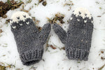 super bulky knit mittens lying in the snow