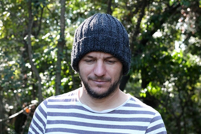 man wearing a knitted mariners hat