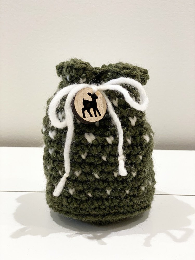 Crochet drawstring bag in white and green yarn