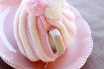 handle view of the pink and white tea cosy