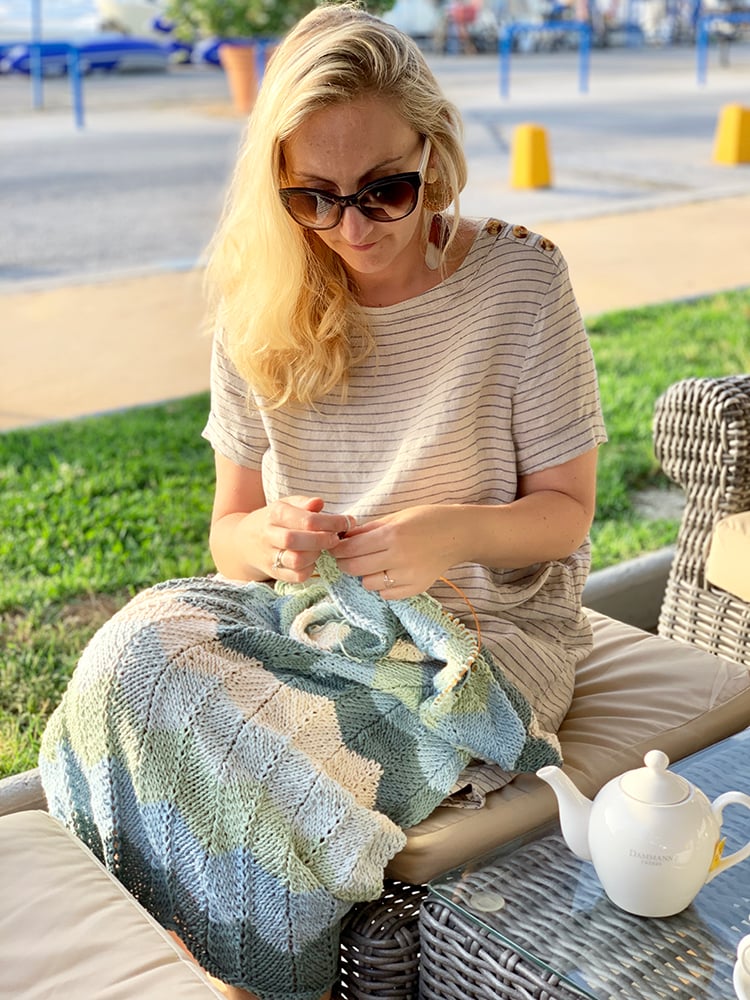 woman sitting knitting in public
