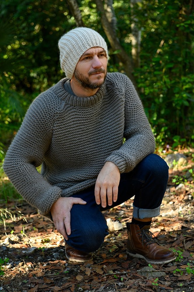 man wearting a knitted sweater and hat